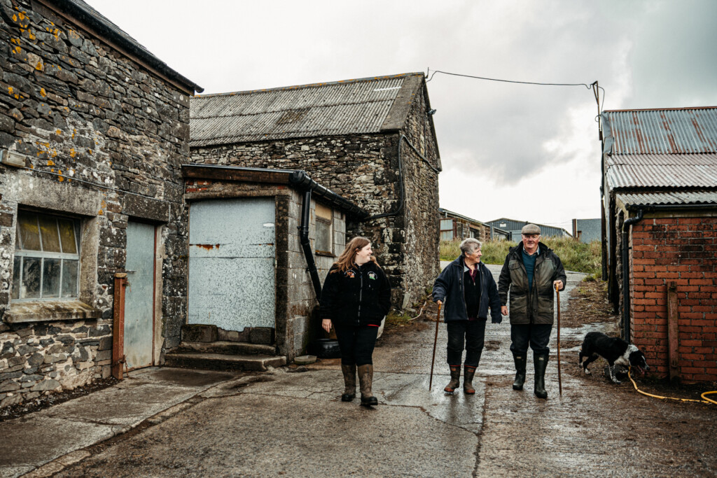 Emily and her parents walking around their farm.