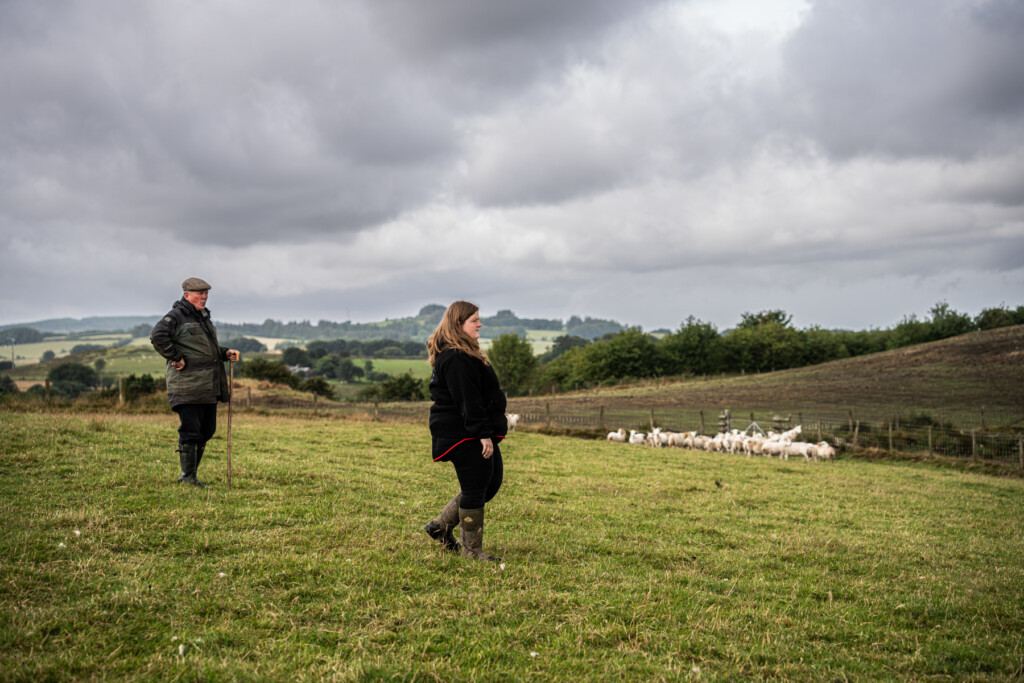 Emily and her father out in the fields with the lamb